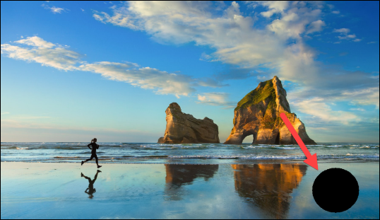 Windows desktop featuring an arrow that is pointing to a black circle on the desktop